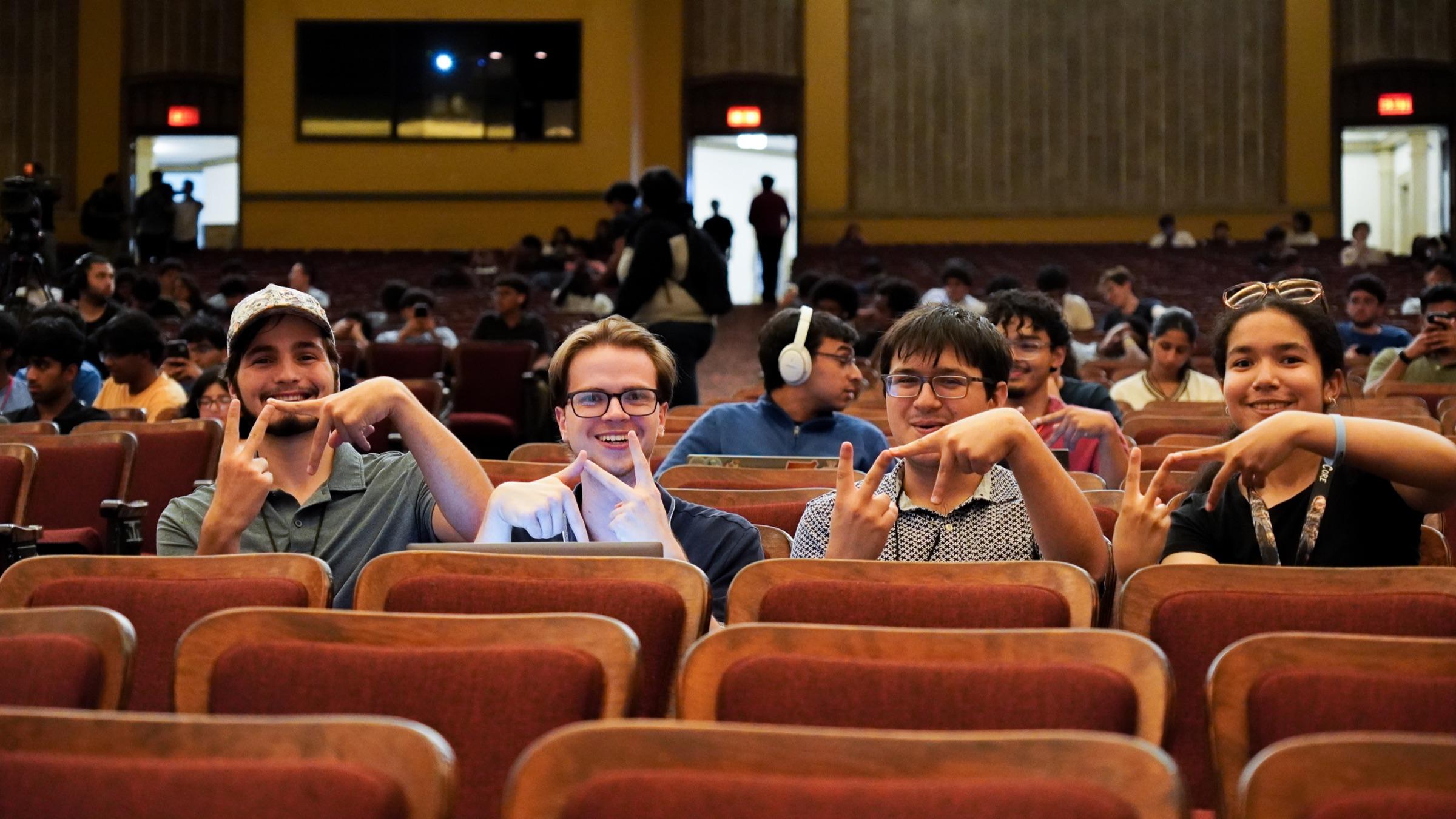 Hackers smiling together in the VTHacks auditorium