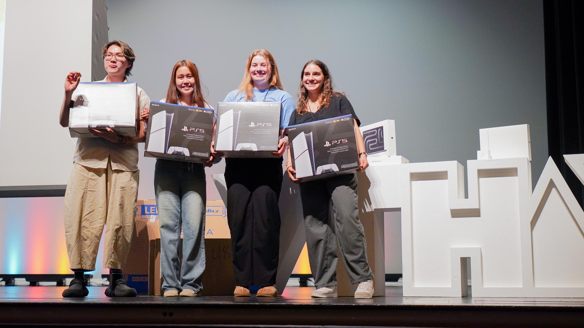 VTHacks 14 winners holding PlayStation 5 prizes on stage